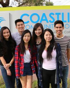 Six students in front of a Coastline Community College sign